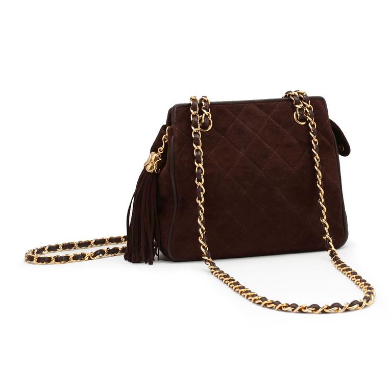 CHANEL, a brown suede purse.