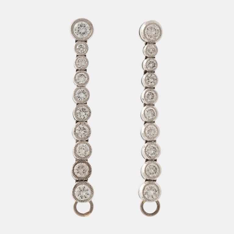 Platinum and brilliant cut diamond line earrings.
