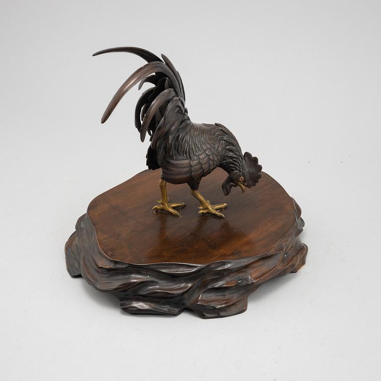 A Japanese bronze sculpture or okimono in the shape of a rooster, Meiji (1868-1912).