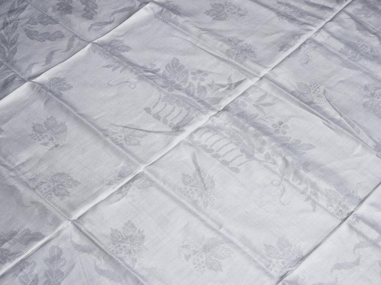 A tea table cloth, linen damask, "Lilla blomsterkorgen", ca 143,5 x 144 cm.