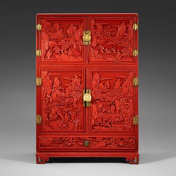 214. A well carved cinnaber lacquer 'Kang' cabinet, Qing dynasty, 18th Century.