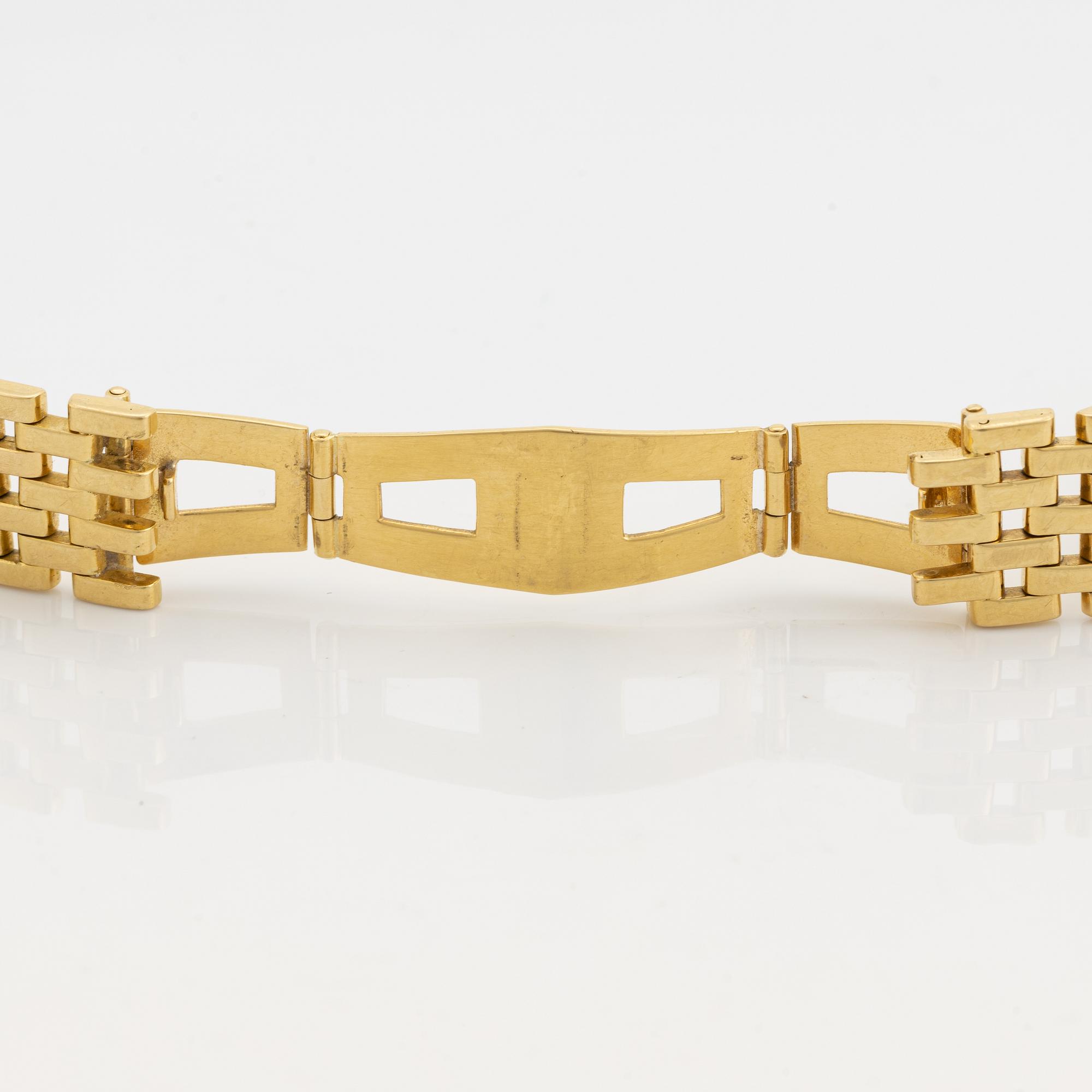 An 18K gold watch bracelet.