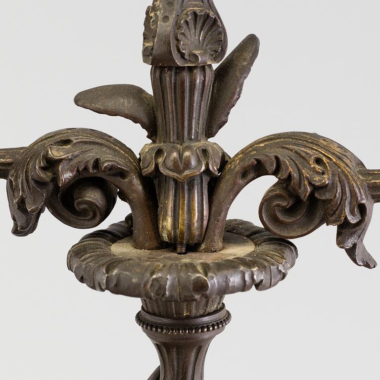 A pair of late 19th century patinated brass candelabra.