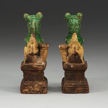 A pair of brown, green and yellow glazed joss stick holders, Qing dynasty (1644-1912).