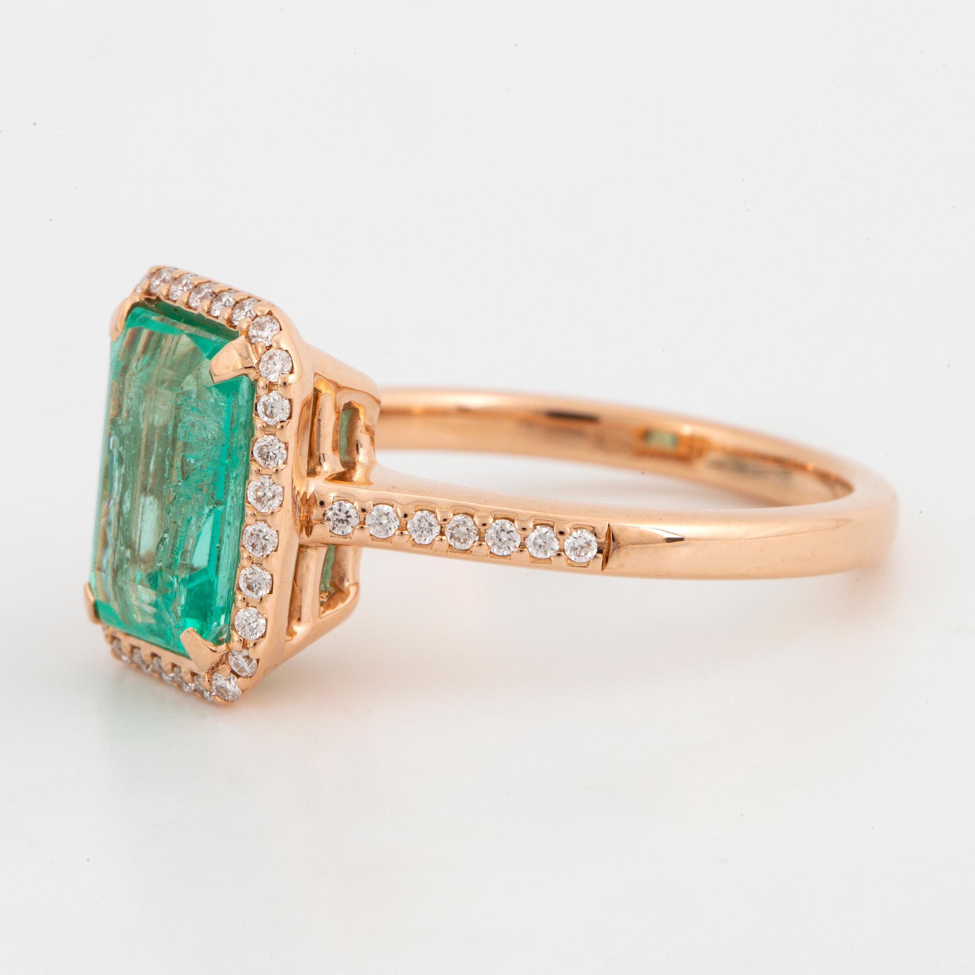 Emerald-cut emerald and brilliant-cut diamond ring.