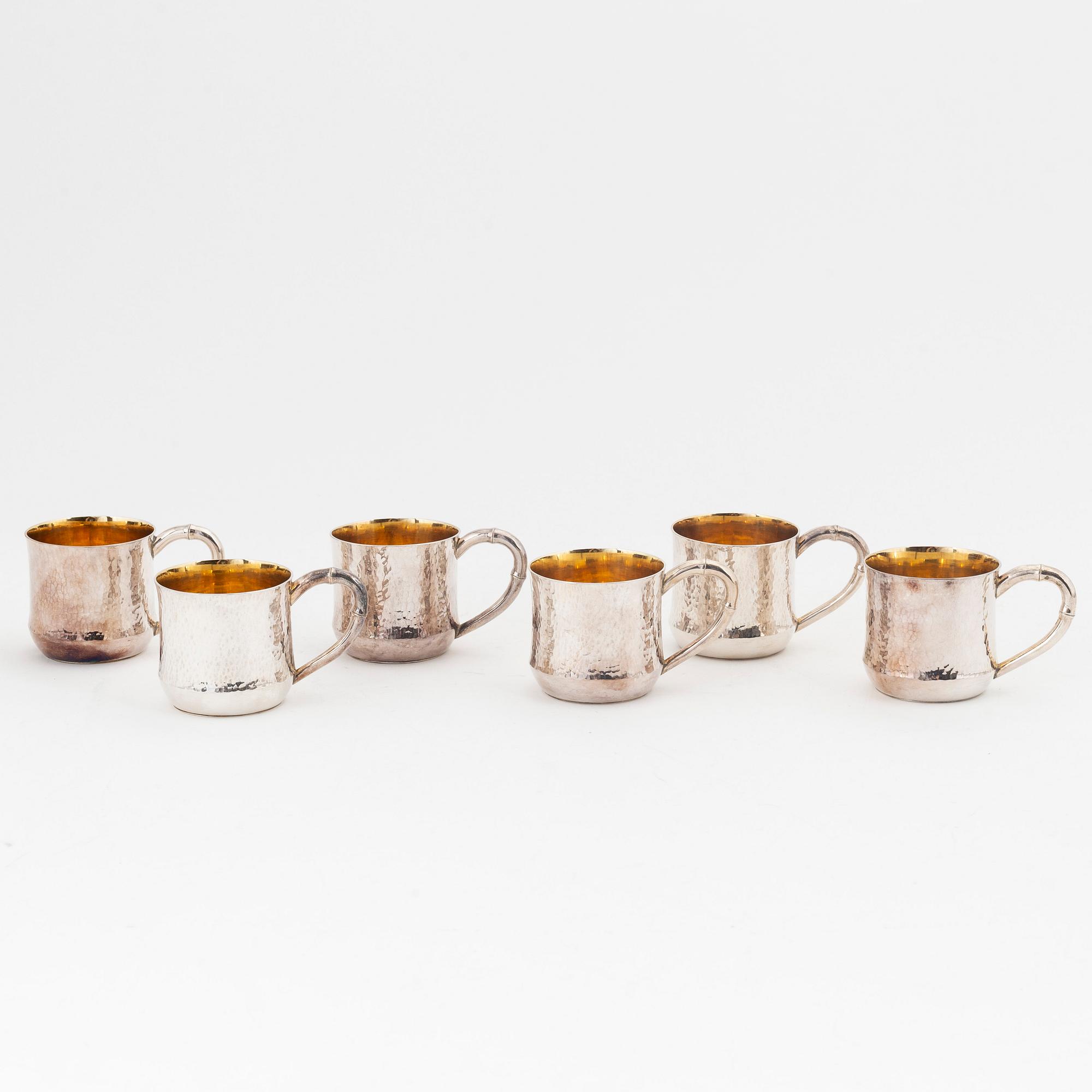 Six parcel-gilt sterling silver jugs.