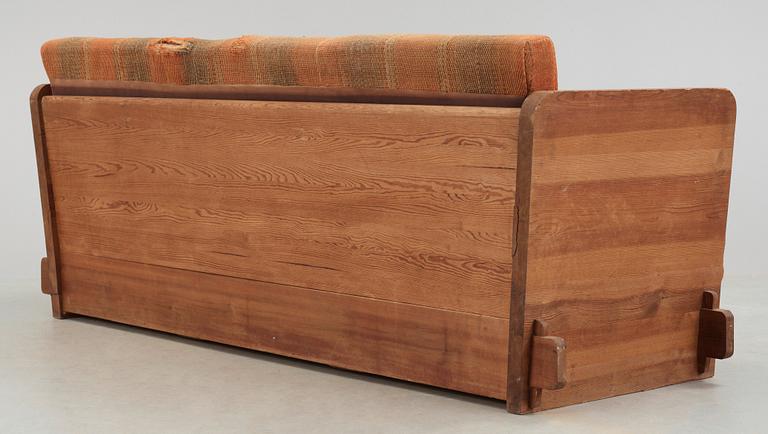 An Axel Einar Hjorth 'Lovö' stained pine sofa, Nordiska Kompaniet, Sweden 1930's.