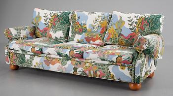 An Arne Norell sofa upholstered in Josef Frank's fabric 'Anakreon'.