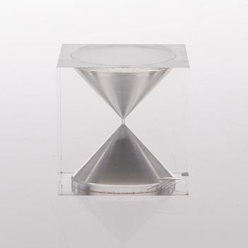 An acrylic hourglass / sand timer with white sand, Vakumotuote oy, monogram signiture TW. Designed in 1980.