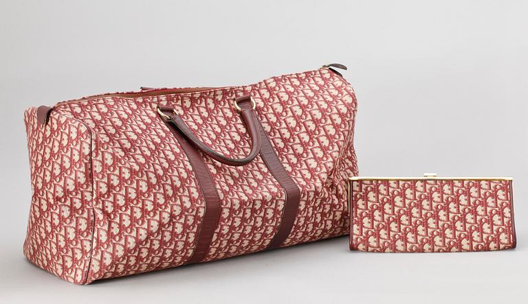 A red monogram canvas weekendbag and clutch by Christian Dior.