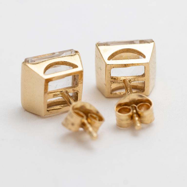 A pair of 18K gold earrings with rock crystal stones.