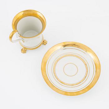 An Empire style porcelain cup and saucer, Germany, circa 1900.