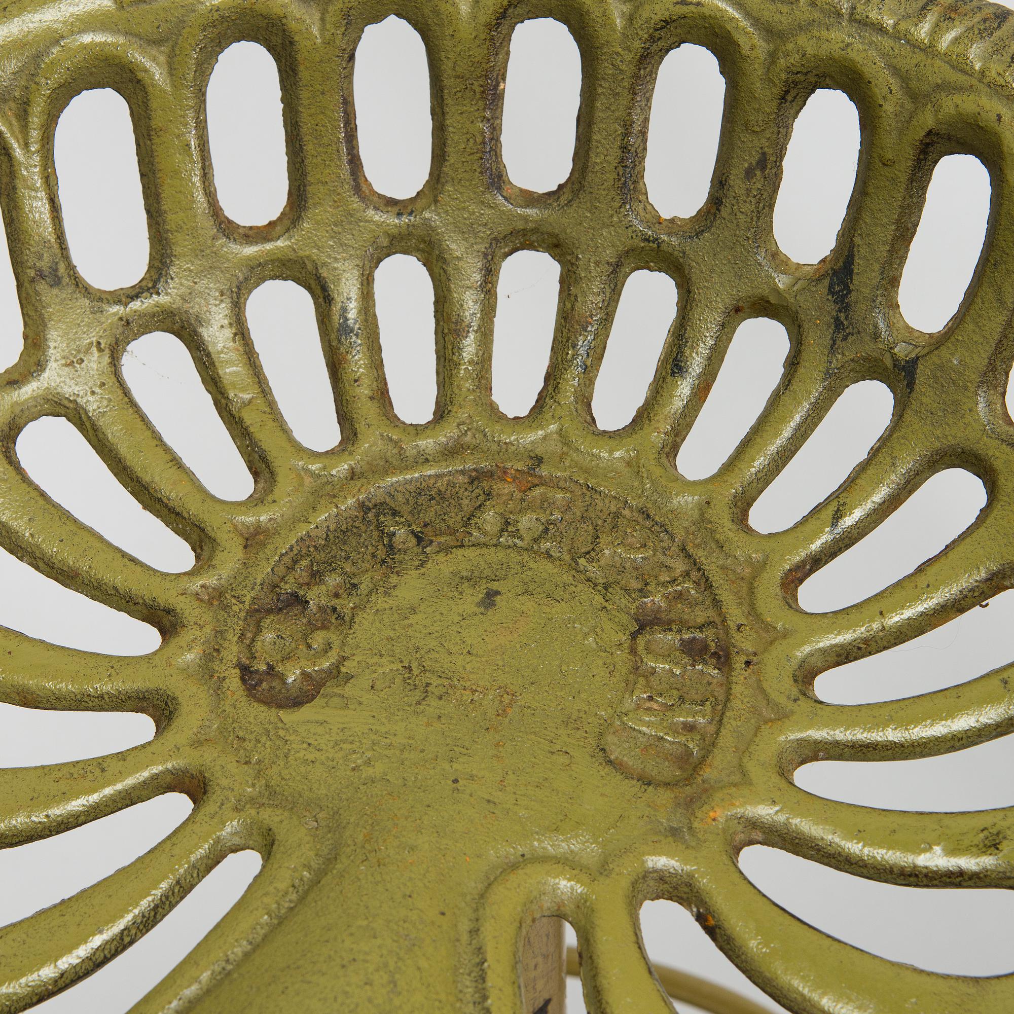 Four bar stools, painted cast iron, partly from the early 20th century.