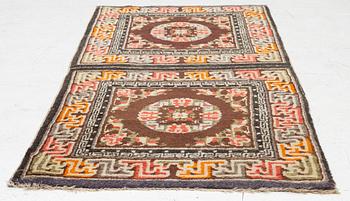 A Chinese two square rug, antique, c. 142 x 71 cm.