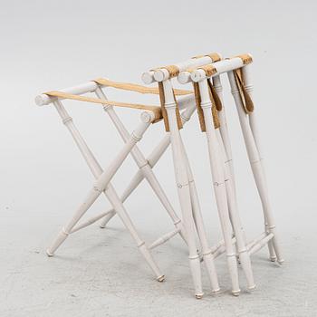 A set of three luggage stands, 20th century.