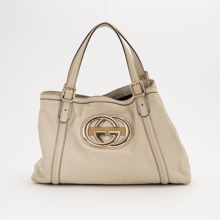 Gucci, a cream leather handbag.