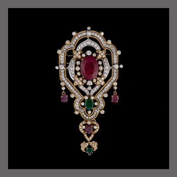 A BROOCH / PENDANT, 18K white and yellow gold, rubies, emeralds, diamonds. Iran. Weight c. 42,6 g.