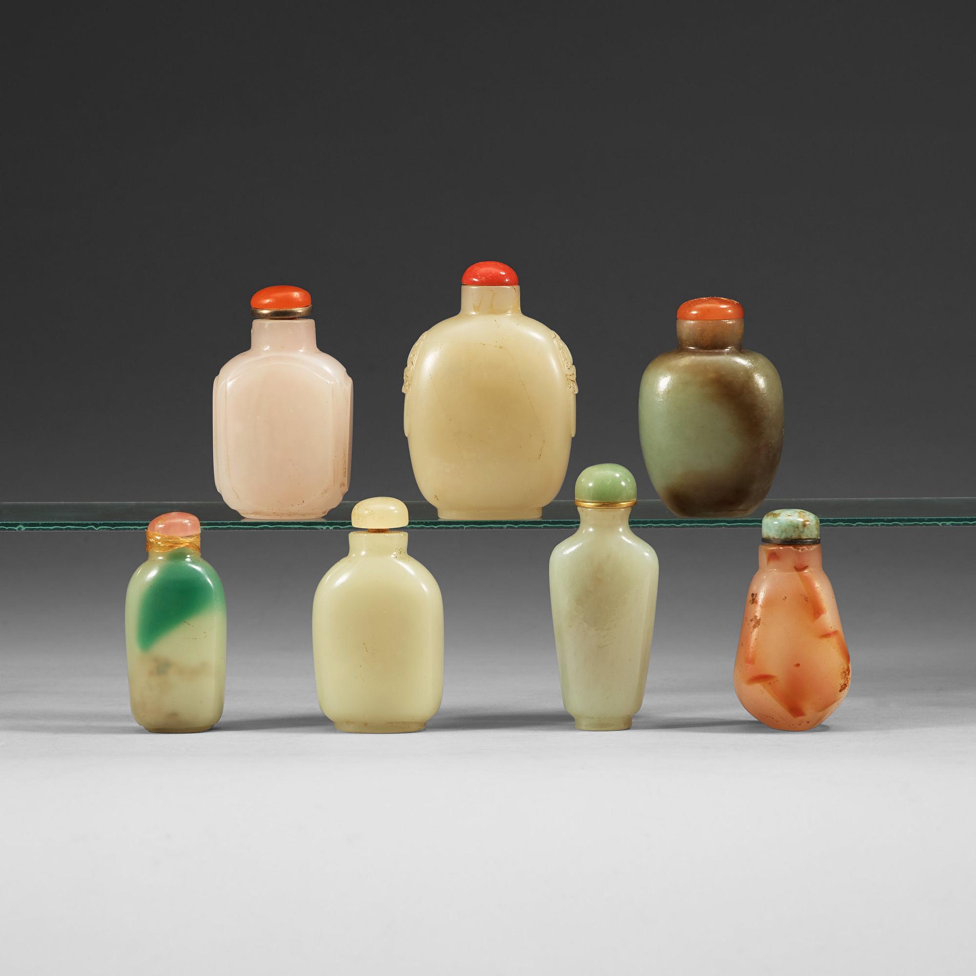 A set of 7 nephrite and stone snuff bottles with stoppers, Qing dynasty (1644-1912).