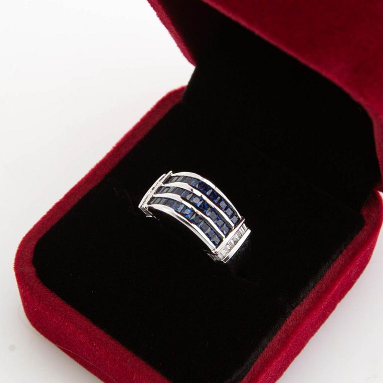 Ring, 18K white gold with baguette-cut diamonds and princess-cut sapphires.