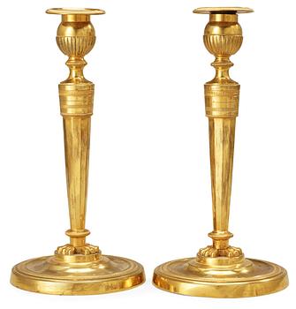 678. A pair of French Empire early 19th Century candlesticks.