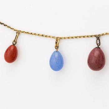 Necklace with jeweled egg, 14K gold and metal.