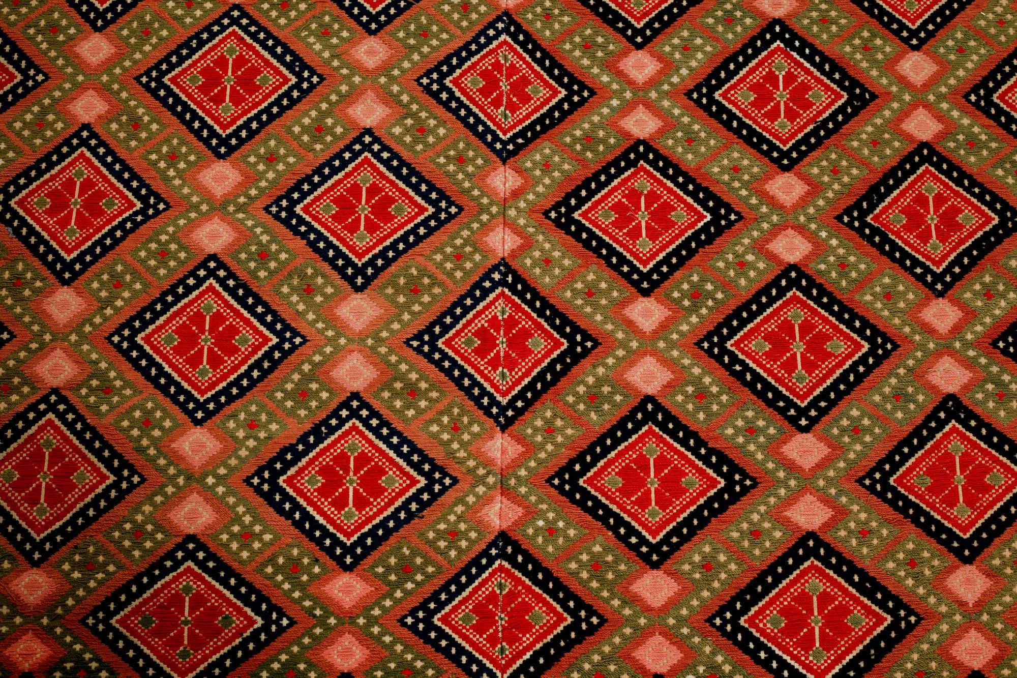 A wall textile, signed, around the year 1900, 208 x 130 cm.