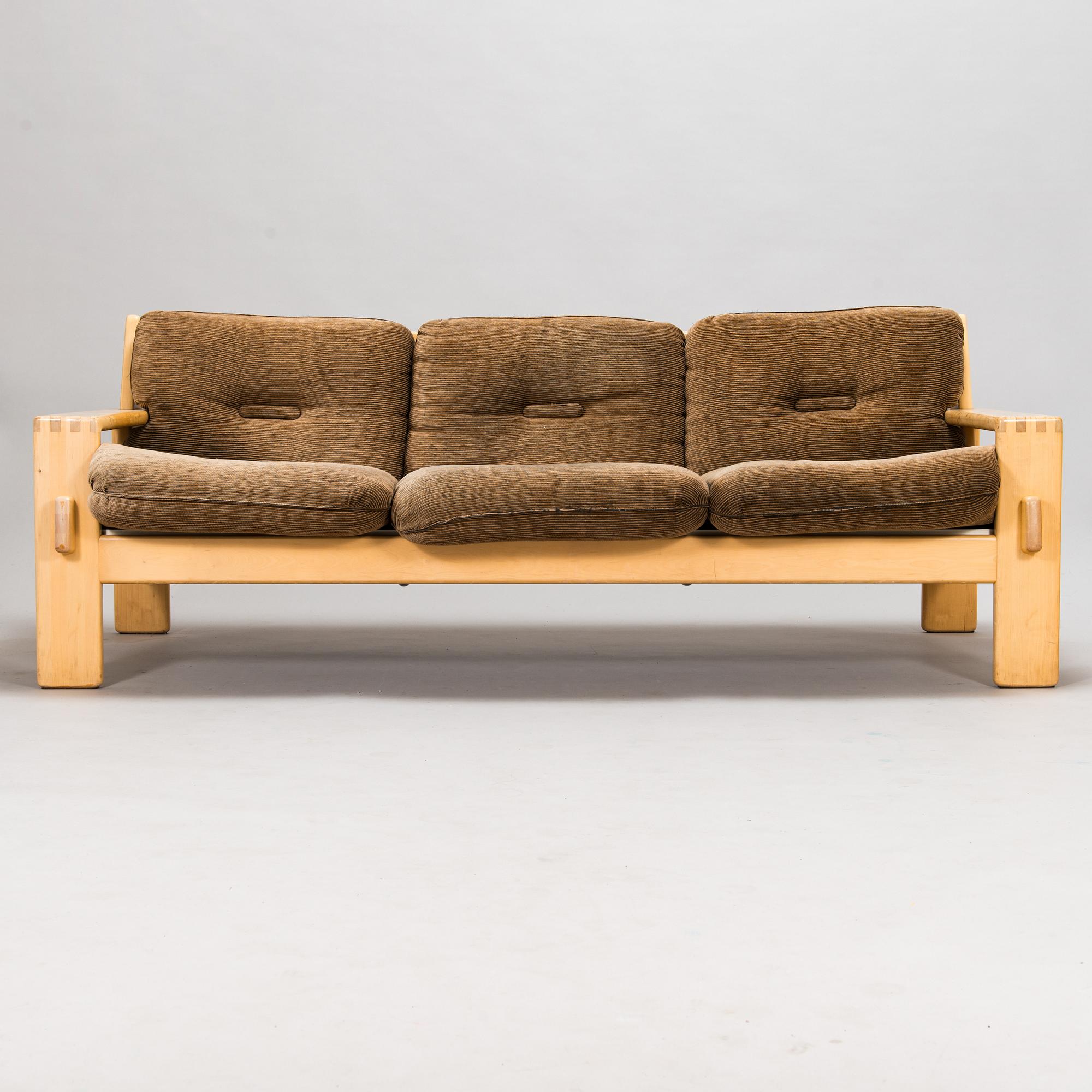 Esko Pajamies, A pair of 1970's 'Bonanza' armchairs, coffee table and sofa for Asko.