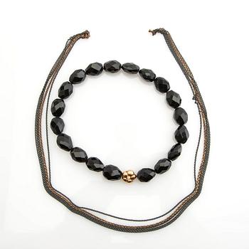 Ole Lynggaard, clasp, 18K gold with a round brilliant-cut diamond, and two necklaces.