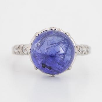 Cabochon-cut tanzanite and brilliant-cut diamond ring.