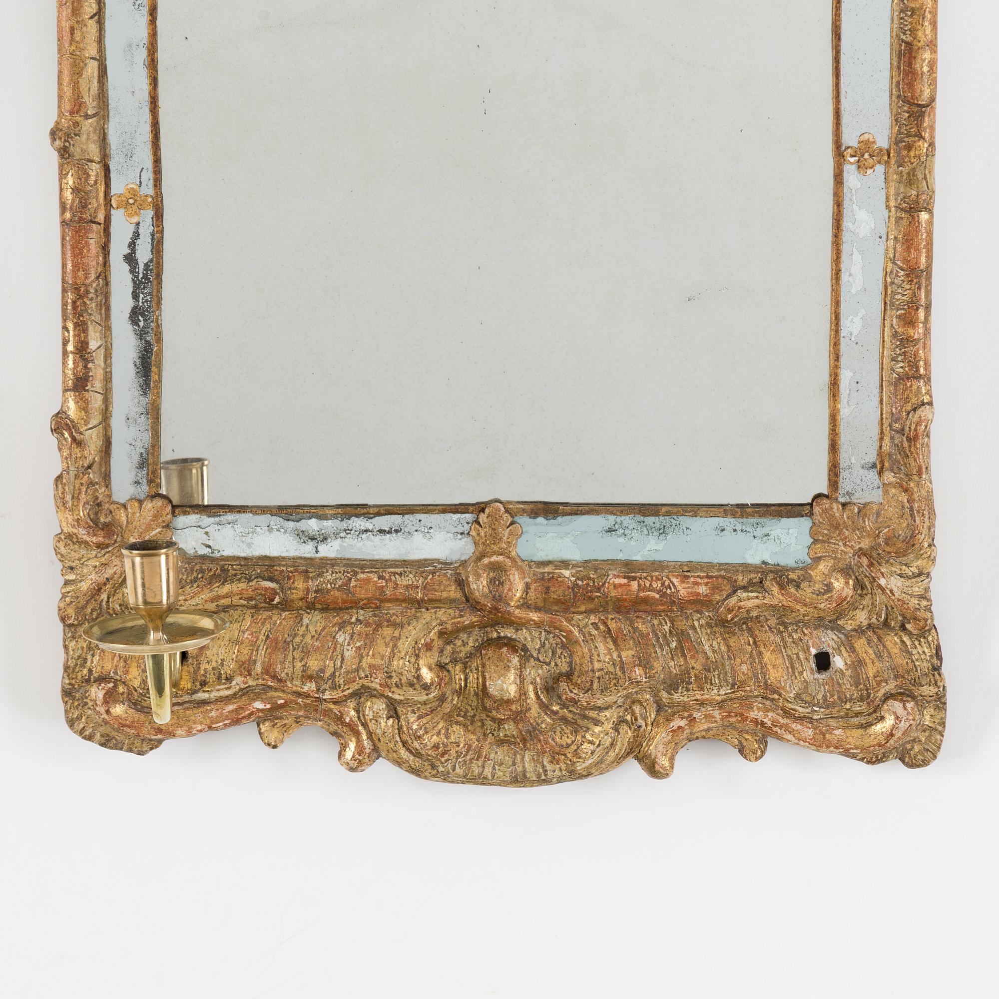 A second half of the 18th century rococo mirror sconce.