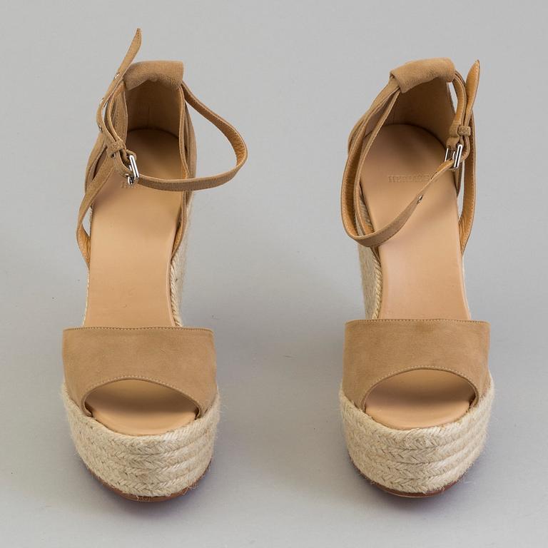 A beige suede platform sandals by Hermès.