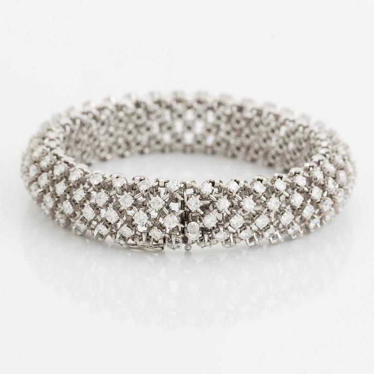 A platinum bracelet set with round brilliant-cut diamonds.