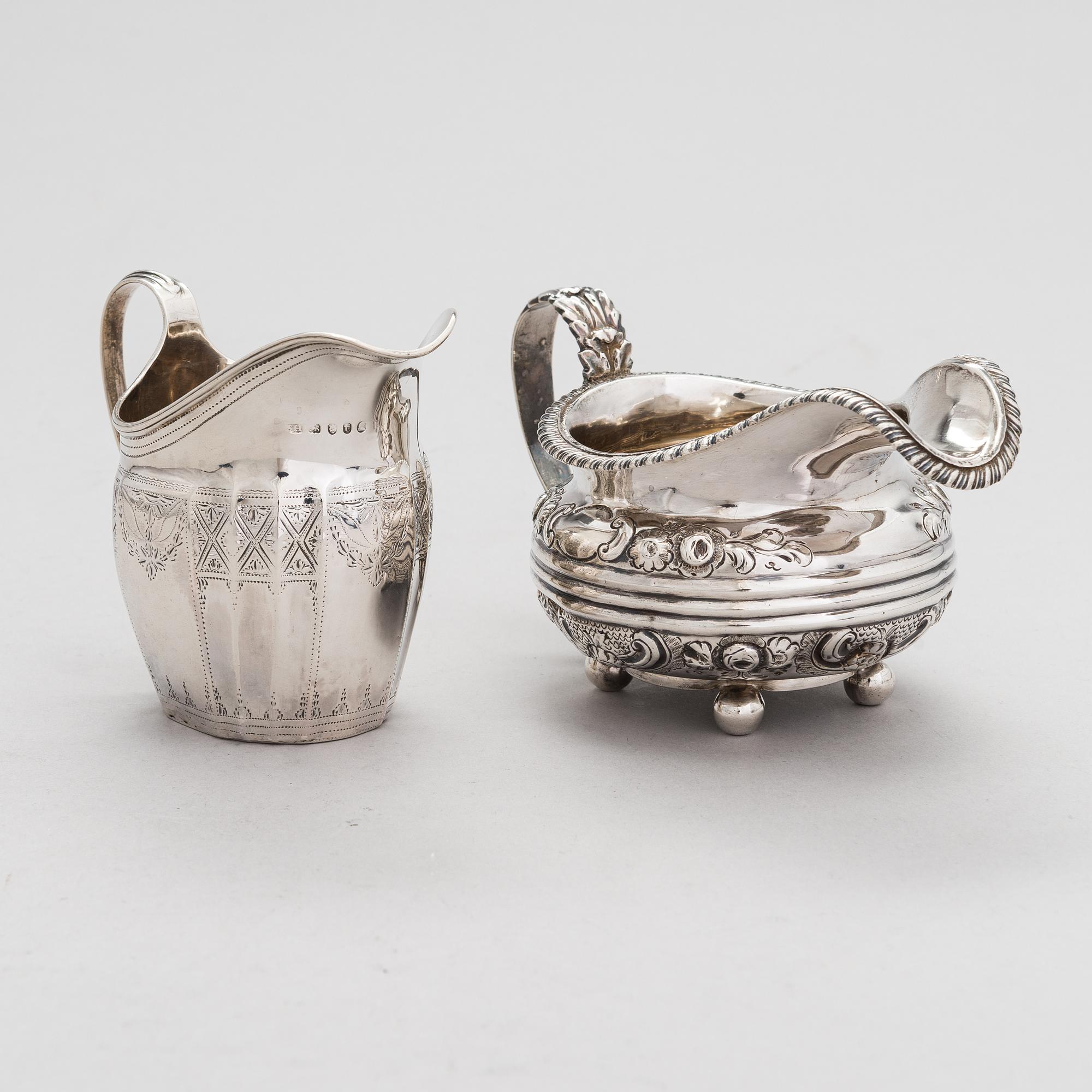 Two sterling silver milk jugs, London 1794 och 1828.