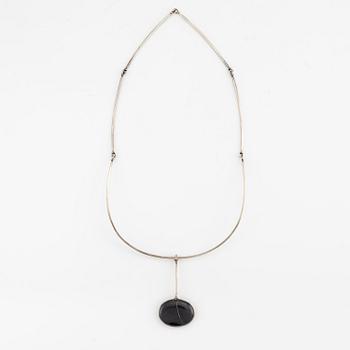 Vivianna Torun Bülow-Hübe, a pendant with chain, silver with a beach pebble, 1963.