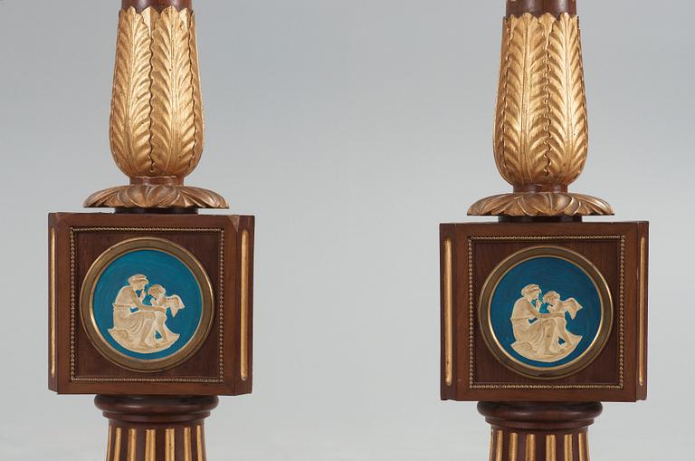 A pair of Empire 19th century candle stands.