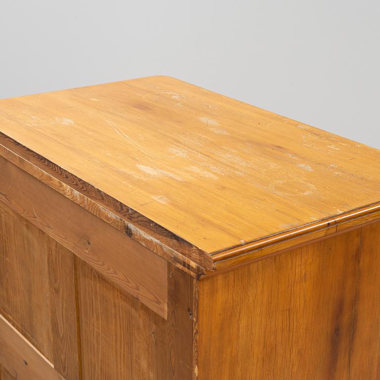 A walnut veneered tall boy dresser, early 20th century.