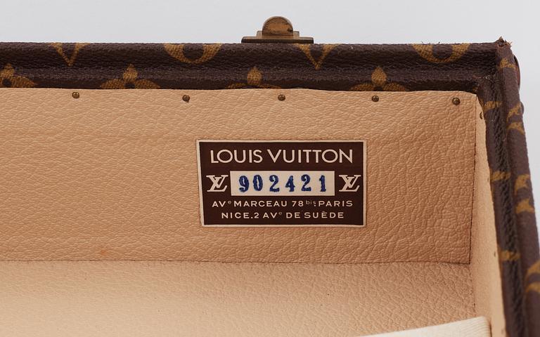 A monogram canvas suitcase by Louis Vuitton.