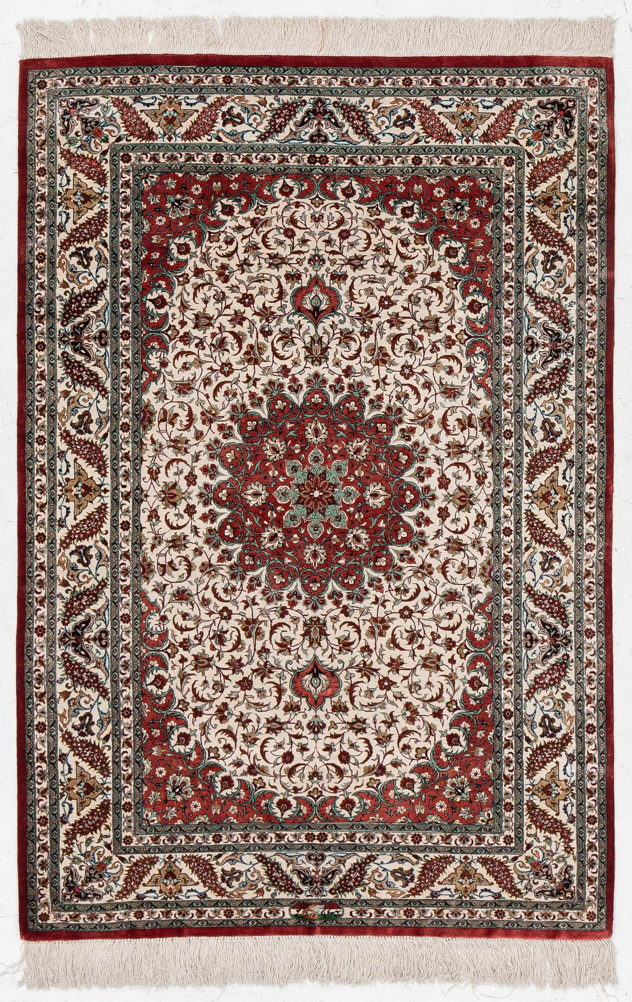 A Ghom silk rug, signed, c. 148 x 100 cm.