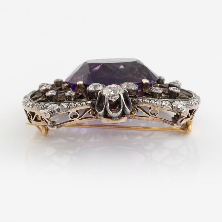 A brooch set with an amethyst and old-cut diamonds.