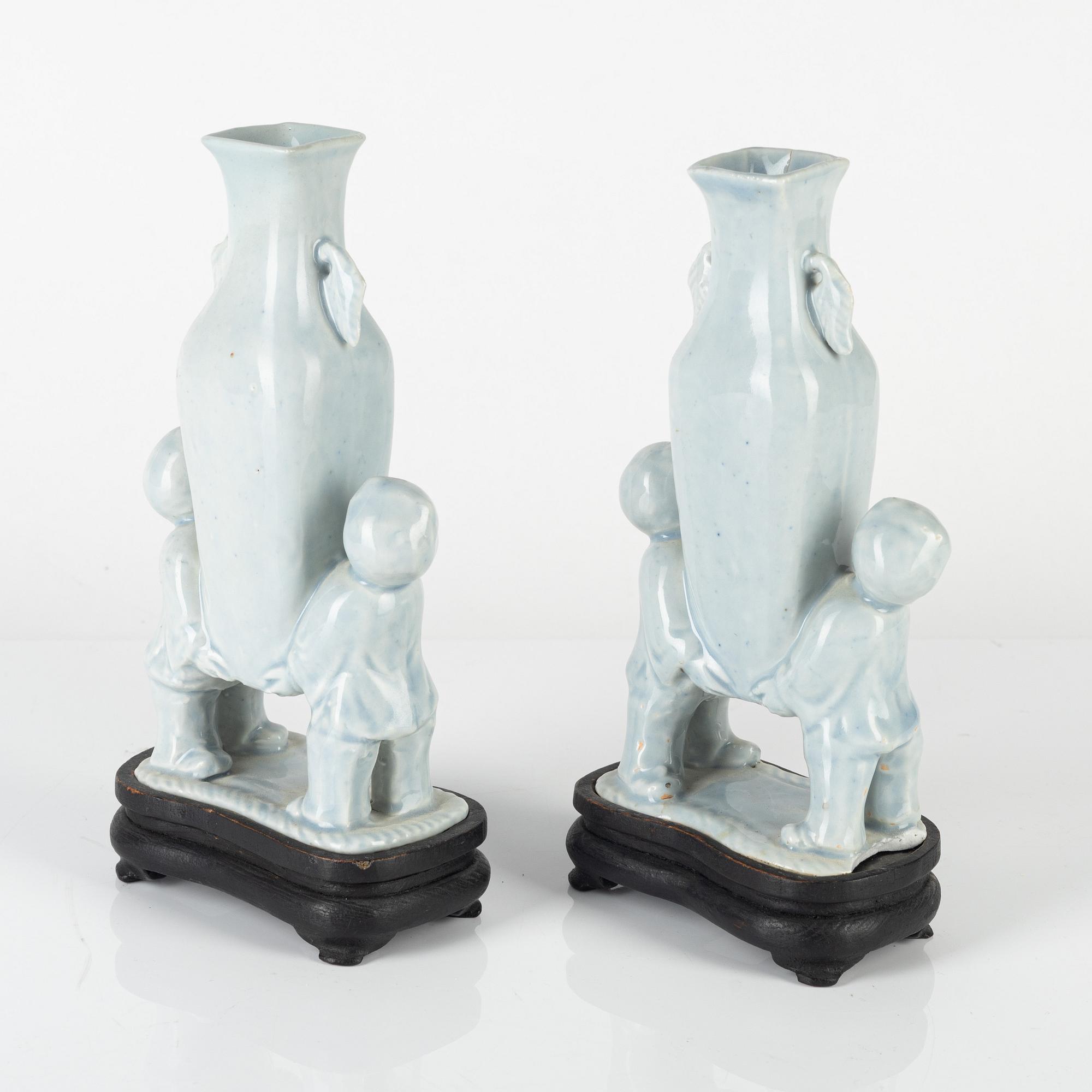 A pair of Chinese pale blue boys vases, around 1900.