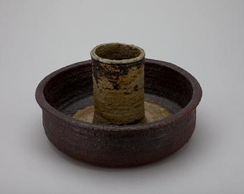A CERAMIC CANDLESTICK.