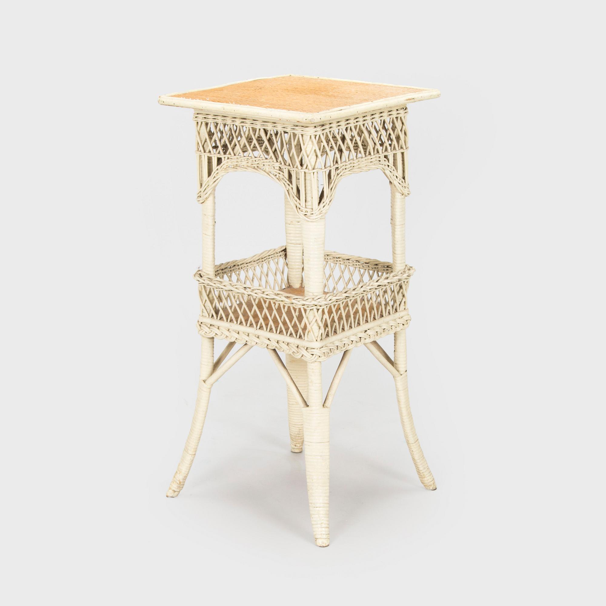 A mid-20th-century three-piece rattan furniture set including two armchairs, and a table.