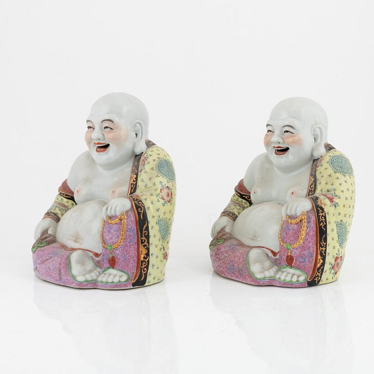 A pair of porcelain laughing Buddhas, China, 20th century.