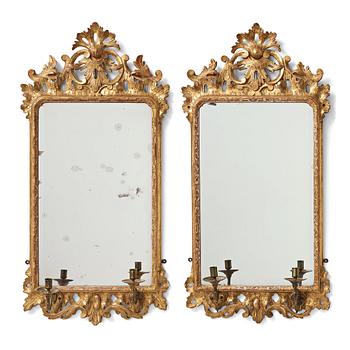 89. A pair of Rococo 18th century two-light girandole mirrors.