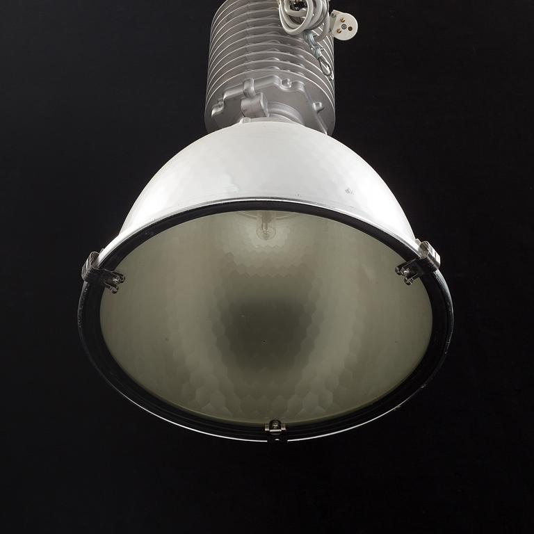 An industrial ceiling lamp marked Zumtobel Staff.