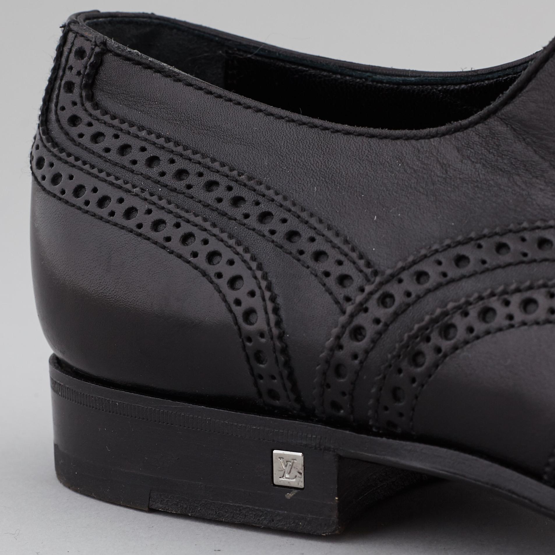 LOUIS VUITTON, a pair of black leather brogues, size 9½.