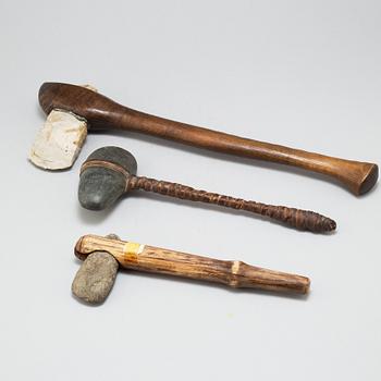 Three stone axes with modern handles.