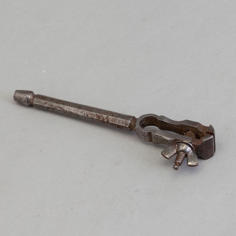 AN 18TH CENTURY STEEL SILVERSMITH'S TOOL.