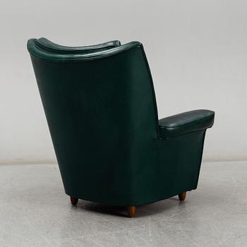 A Collins & Hayes armchair, mid 20th century. Signed with label.