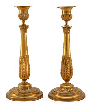 A PAIR OF EMPIRE CANDLESTICKS.